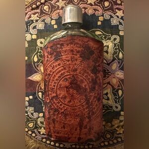 Vintage antique glass flask with a tooled leather cover